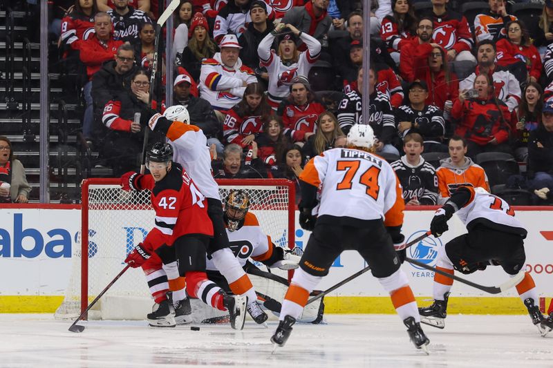 Jan 18, 2025; Newark, New Jersey, USA; New Jersey Devils center Curtis Lazar (42) looks for the puck after a save by Philadelphia Flyers goaltender Samuel Ersson (33) during the third period at Prudential Center. Mandatory Credit: Ed Mulholland-Imagn Images