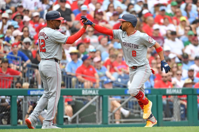 May 19, 2024; Philadelphia, Pennsylvania, USA; Washington Nationals outfielder Eddie Rosario (8) high fives third base coach Ricky Gutierrez (12) after hitting a two run home run against the Philadelphia Phillies during the fourth inning at Citizens Bank Park. Mandatory Credit: Eric Hartline-USA TODAY Sports