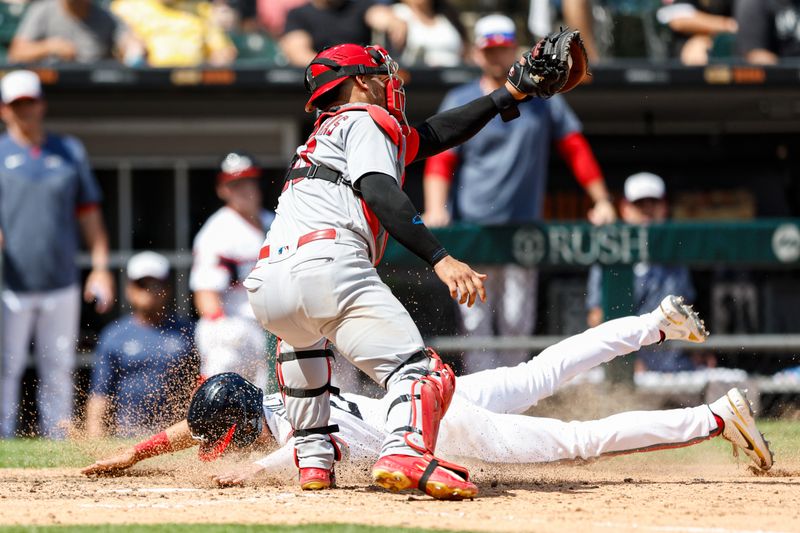 Jul 9, 2023; Chicago, Illinois, USA; Chicago White Sox shortstop Zach Remillard (28) scores against St. Louis Cardinals catcher Willson Contreras (40) during the eight inning at Guaranteed Rate Field. Mandatory Credit: Kamil Krzaczynski-USA TODAY Sports