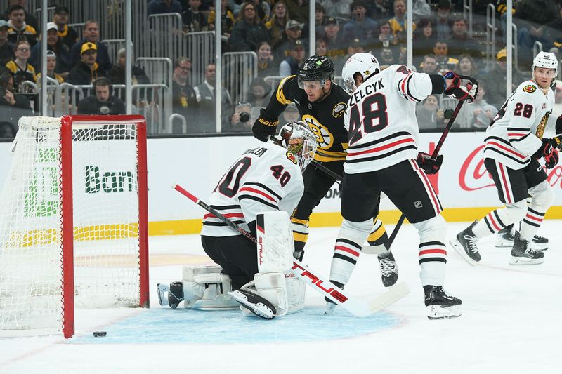 Oct 9, 2025; Boston, Massachusetts, USA; Boston Bruins center Casey Mittelstadt (11) scores a goal past Chicago Blackhawks goaltender Arvid Soderblom (40) during the first period at TD Garden. Mandatory Credit: Bob DeChiara-Imagn Images