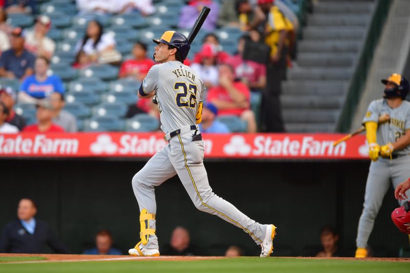 Jun 18, 2024; Anaheim, California, USA; Milwaukee Brewers outfielder Christian Yelich (22) hits a solo home run against the Los Angeles Angels during the first inning at Angel Stadium. Mandatory Credit: Gary A. Vasquez-USA TODAY Sports