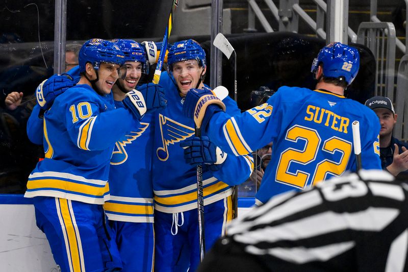 Nov 2, 2024; St. Louis, Missouri, USA;  St. Louis Blues center Jordan Kyrou (25) celebrates with center Brayden Schenn (10) center Dylan Holloway (81) and defenseman Ryan Suter (22) after scoring against the Toronto Maple Leafs during the second period at Enterprise Center. Mandatory Credit: Jeff Curry-Imagn Images