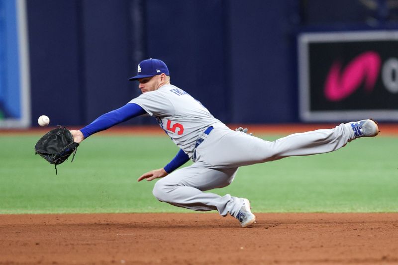 May 26, 2023; St. Petersburg, Florida, USA;  Los Angeles Dodgers first baseman Freddie Freeman (5) dives for a ball against the Tampa Bay Rays in the seventh inning at Tropicana Field. Mandatory Credit: Nathan Ray Seebeck-USA TODAY Sports