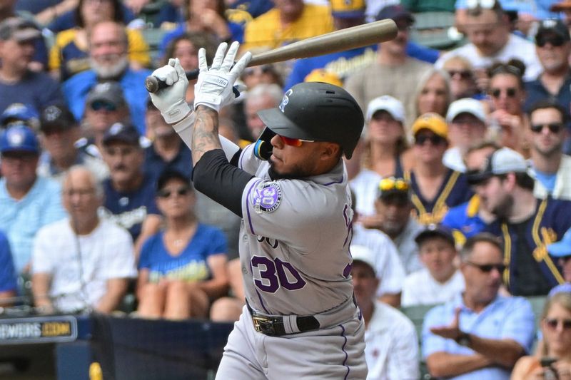 Aug 9, 2023; Milwaukee, Wisconsin, USA; Colorado Rockies second baseman Harold Castro (30) singles to drive in two runs against the Milwaukee Brewers in the fourth inning at American Family Field. Mandatory Credit: Benny Sieu-USA TODAY Sports