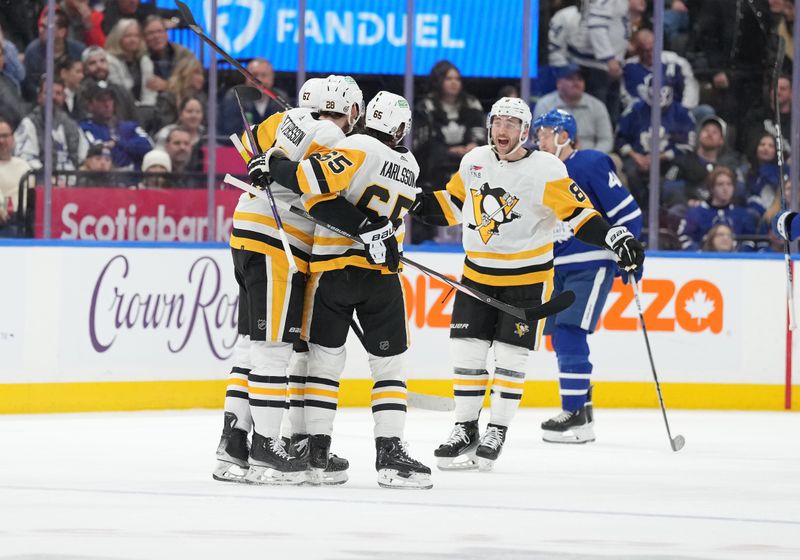 Apr 8, 2024; Toronto, Ontario, CAN; Pittsburgh Penguins right wing Rickard Rakell (67) is mobbed by teammates after he scores a goal against the Toronto Maple Leafs during the first period at Scotiabank Arena. Mandatory Credit: Nick Turchiaro-USA TODAY Sports
