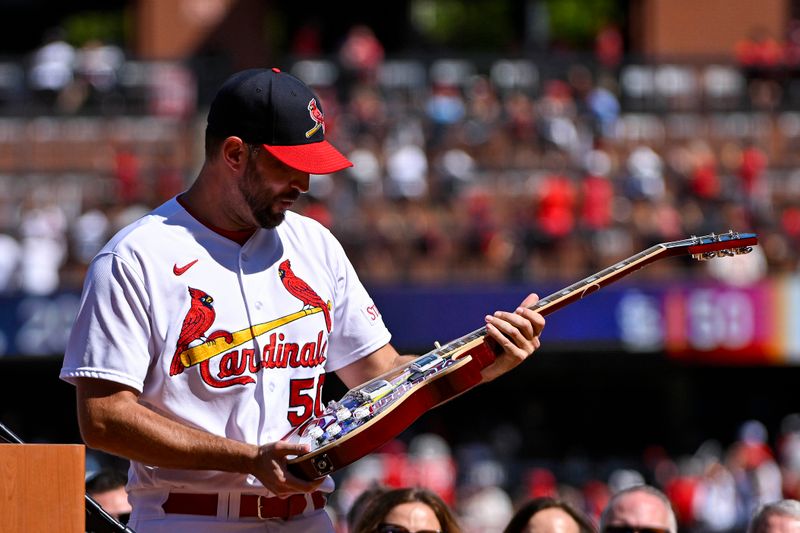 Oct 1, 2023; St. Louis, Missouri, USA; St. Louis Cardinals starting pitcher Adam Wainwright (50) reacts as he receives a guitar as a retirement gift during his retirement ceremony before a game against the Cincinnati Reds at Busch Stadium. Mandatory Credit: Jeff Curry-USA TODAY Sports