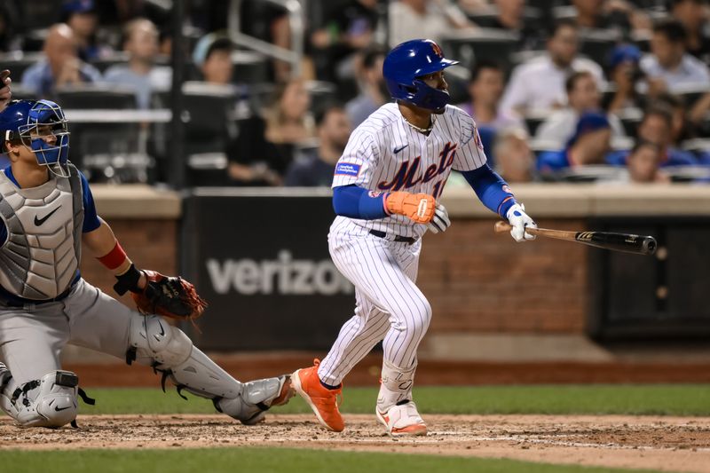 Aug 9, 2023; New York City, New York, USA; New York Mets shortstop Francisco Lindor (12) hits a single against the Chicago Cubs during the fourth inning at Citi Field. Mandatory Credit: John Jones-USA TODAY Sports