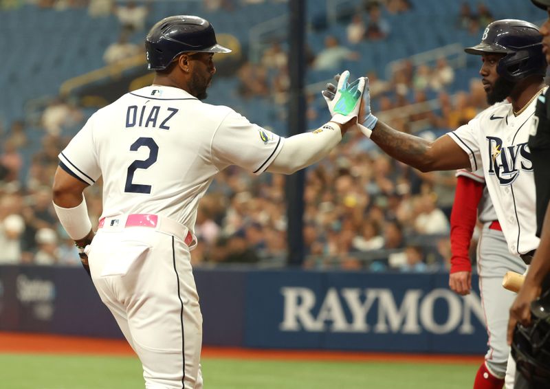 Sep 21, 2023; St. Petersburg, Florida, USA; Tampa Bay Rays first baseman Yandy Diaz (2) is congratulated by Tampa Bay Rays left fielder Randy Arozarena (56) after he scored a run against the Los Angeles Angels during the first inning at Tropicana Field. Mandatory Credit: Kim Klement Neitzel-USA TODAY Sports