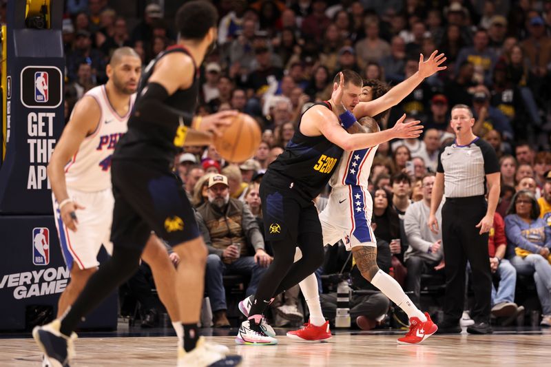 DENVER, COLORADO - JANUARY 27: Nikola Jokic #15 of the Denver Nuggets and Kelly Oubre Jr. #9 of the Philadelphia 76ers compete for position in the first half at Ball Arena on January 27, 2024 in Denver, Colorado. NOTE TO USER: User expressly acknowledges and agrees that, by downloading and/or using this photograph, user is consenting to the terms and conditions of the Getty Images License Agreement. (Photo by Justin Tafoya/Getty Images)