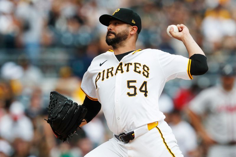 May 26, 2024; Pittsburgh, Pennsylvania, USA;  Pittsburgh Pirates starting pitcher Martín Pérez (54) delivers a pitch against the Atlanta Braves during the first inning at PNC Park. Mandatory Credit: Charles LeClaire-USA TODAY Sports