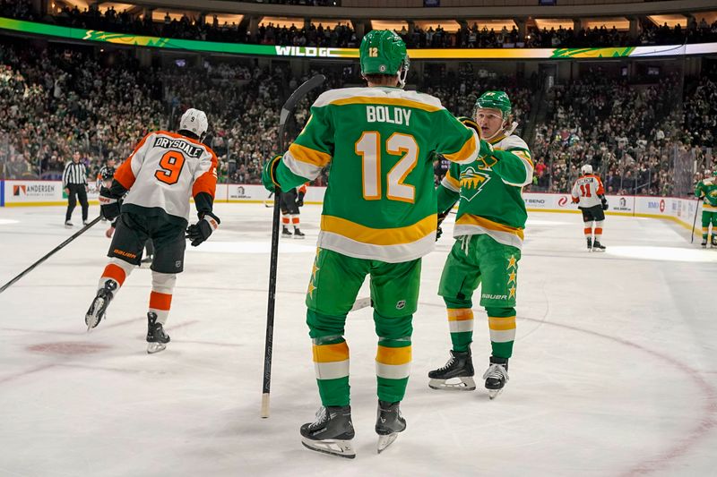 Dec 14, 2024; Saint Paul, Minnesota, USA;  Minnesota Wild forward Matt Boldy (12) celebrates with forward Kirill Kaprizov (97) after scoring a goal against the Philadelphia Flyers during the second period at Xcel Energy Center. Mandatory Credit: Nick Wosika-Imagn Images