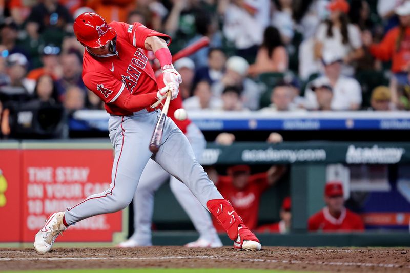 Apr 13, 2025; Houston, Texas, USA; Los Angeles Angels pinch hitter Logan O'Hoppe (14) hits a single while breaking his bat against the Houston Astros during the seventh inning at Daikin Park. Mandatory Credit: Erik Williams-Imagn Images
