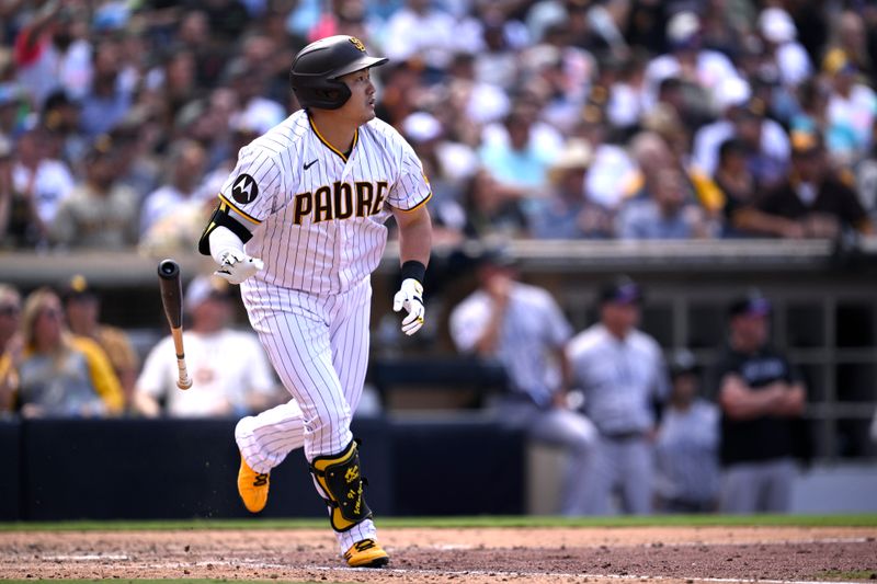 Sep 20, 2023; San Diego, California, USA; San Diego Padres pinch hitter Ji-Man Choi (91) hits a sacrifice fly against the Colorado Rockies during the seventh inning at Petco Park. Mandatory Credit: Orlando Ramirez-USA TODAY Sports