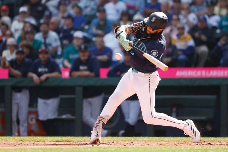 Sep 19, 2024; Seattle, Washington, USA; Seattle Mariners shortstop J.P. Crawford (3) hits an RBI-single against the New York Yankees during the first inning at T-Mobile Park. Mandatory Credit: Joe Nicholson-Imagn Images