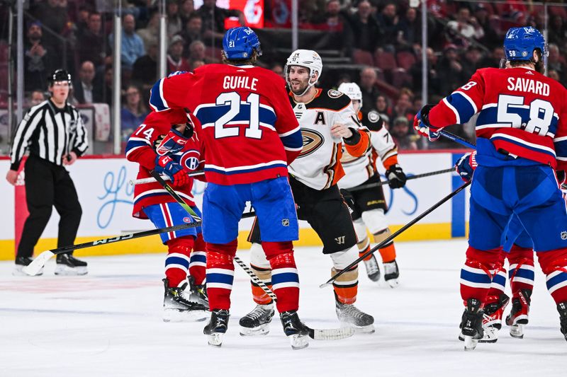 Feb 13, 2024; Montreal, Quebec, CAN; Montreal Canadiens defenseman Kaiden Guhle (21) fights with Anaheim Ducks center Adam Henrique (14) during the third period at Bell Centre. Mandatory Credit: David Kirouac-USA TODAY Sports