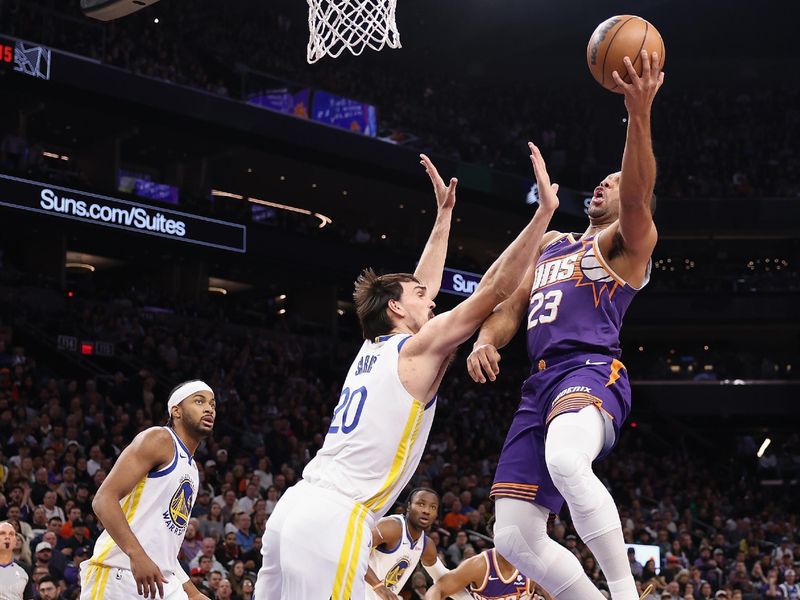 PHOENIX, ARIZONA - DECEMBER 12: Eric Gordon #23 of the Phoenix Suns lays up a shot over Dario Saric #20 of the Golden State Warriors during the first half of the NBA game at Footprint Center on December 12, 2023 in Phoenix, Arizona. NOTE TO USER: User expressly acknowledges and agrees that, by downloading and or using this photograph, User is consenting to the terms and conditions of the Getty Images License Agreement.  (Photo by Christian Petersen/Getty Images)