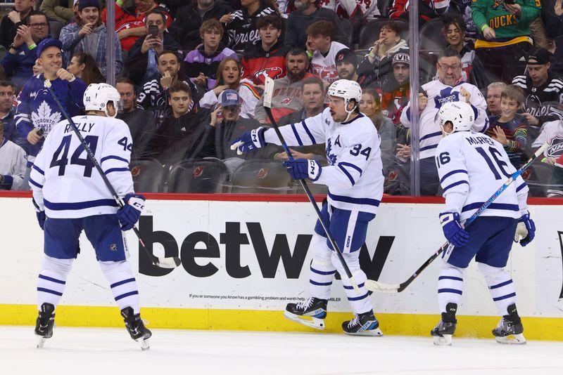 Mar 7, 2023; Newark, New Jersey, USA; Toronto Maple Leafs center Auston Matthews (34) celebrates his goal against the New Jersey Devils during the third period at Prudential Center. Mandatory Credit: Ed Mulholland-USA TODAY Sports