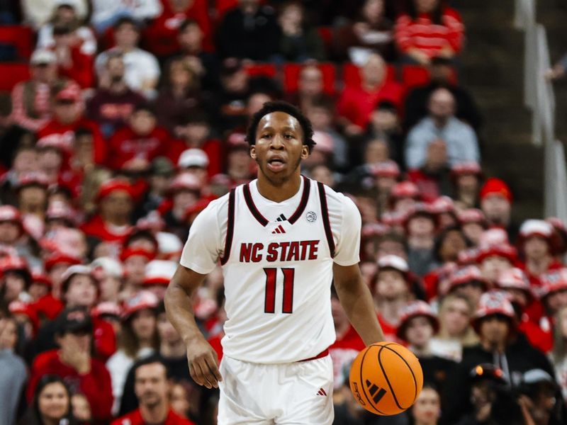 Feb 7, 2026; Raleigh, North Carolina, USA; NC State Wolfpack guard Quadir Copeland (11) dribbles the ball during the first half of the game against the Virginia Tech Hokies at Lenovo Center. Mandatory Credit: Jaylynn Nash-Imagn Images