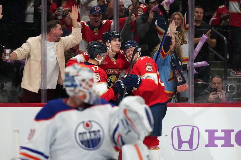 Nov 20, 2023; Sunrise, Florida, USA; Florida Panthers defenseman Niko Mikkola (77) celebrates his goal against the Edmonton Oilers with teammates on the ice during the second period at Amerant Bank Arena. Mandatory Credit: Jasen Vinlove-USA TODAY Sports