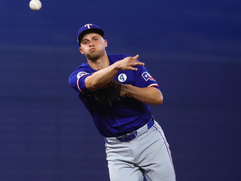 Jun 2, 2024; Miami, Florida, USA; Texas Rangers shortstop Corey Seager (5) throws to first base against the Miami Marlins during the seventh inning at loanDepot Park. Mandatory Credit: Sam Navarro-USA TODAY Sports