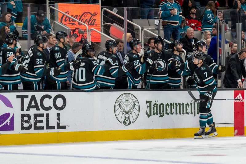 Feb 27, 2024; San Jose, California, USA;  San Jose Sharks center Nico Sturm (7) celebrates with teammates after the goal against the New Jersey Devils during the first period at SAP Center at San Jose. Mandatory Credit: Neville E. Guard-USA TODAY Sports