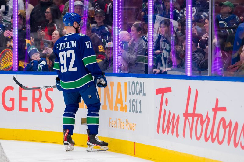 Mar 9, 2024; Vancouver, British Columbia, CAN; Vancouver Canucks forward Vasily Podkolzin (92) interacts with fans  during warm up prior to a game against the Winnipeg Jets at Rogers Arena. Mandatory Credit: Bob Frid-USA TODAY Sports