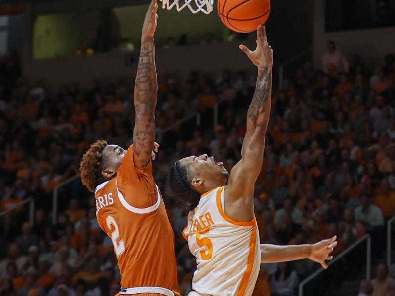 Jan 28, 2023; Knoxville, Tennessee, USA; Tennessee Volunteers guard Zakai Zeigler (5) goes to the basket against Texas Longhorns guard Arterio Morris (2) during the second half at Thompson-Boling Arena. Mandatory Credit: Randy Sartin-USA TODAY Sports