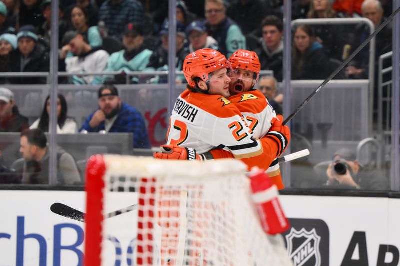 Nov 27, 2024; Seattle, Washington, USA; Anaheim Ducks center Mason McTavish (23) and left wing Alex Killorn (17) celebrate after Killorn scored a goal against the Seattle Kraken during the second period at Climate Pledge Arena. Mandatory Credit: Steven Bisig-Imagn Images