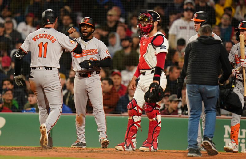 Apr 10, 2024; Boston, Massachusetts, USA; Baltimore Orioles third baseman Jordan Westburg (11) is congratulated after hitting a three run home run against tech Boston Red Sox in the seventh inning at Fenway Park. Mandatory Credit: David Butler II-USA TODAY Sports