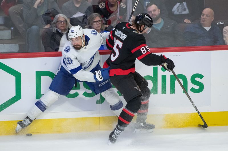 Nov 4, 2023; Ottawa, Ontario, CAN; Tampa Bay Lightning left wing Nicholas Paul (20) battle  with Ottawa Senators defenseman Jake Sanderson (85) for control of the puck in the third period at the Canadian Tire Centre. Mandatory Credit: Marc DesRosiers-USA TODAY Sports