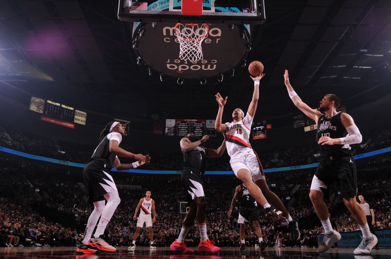 PORTLAND, OR - MARCH 22:  Moses Brown #10 of the Portland Trail Blazers goes to the basket during the game on March 22, 2024 at the Moda Center Arena in Portland, Oregon. NOTE TO USER: User expressly acknowledges and agrees that, by downloading and or using this photograph, user is consenting to the terms and conditions of the Getty Images License Agreement. Mandatory Copyright Notice: Copyright 2024 NBAE (Photo by Cameron Browne/NBAE via Getty Images)