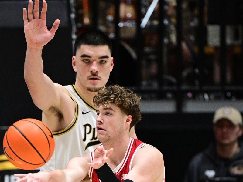 Mar 10, 2024; West Lafayette, Indiana, USA; Wisconsin Badgers guard Max Klesmit (11) passes the ball away from Purdue Boilermakers center Zach Edey (15) during the second half at Mackey Arena. Mandatory Credit: Marc Lebryk-USA TODAY Sports