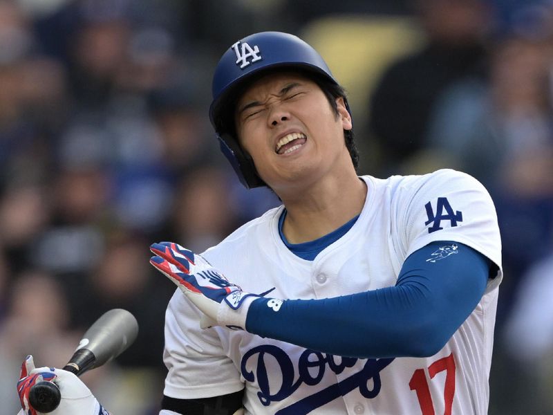 Apr 14, 2024; Los Angeles, California, USA; Los Angeles Dodgers designated hitter Shohei Ohtani (17) reacts after fouling a ball off his foot in the sixth inning against the San Diego Padres at Dodger Stadium. Mandatory Credit: Jayne Kamin-Oncea-USA TODAY Sports