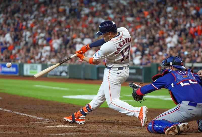 Apr 13, 2024; Houston, Texas, USA; Houston Astros pitch hitter Victor Caratini (17) hits an RBI single against the Texas Rangers  in the seventh inning at Minute Maid Park. Mandatory Credit: Thomas Shea-USA TODAY Sports