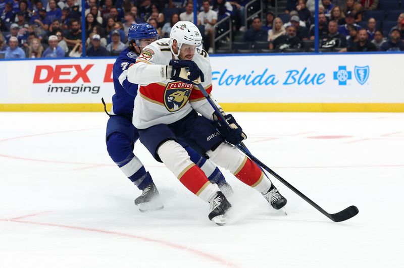 Oct 5, 2023; Tampa, Florida, USA; Florida Panthers defenseman Oliver Ekman-Larsson (91) defends Tampa Bay Lightning center Brayden Point (21) during the second period at Amalie Arena. Mandatory Credit: Kim Klement Neitzel-USA TODAY Sports