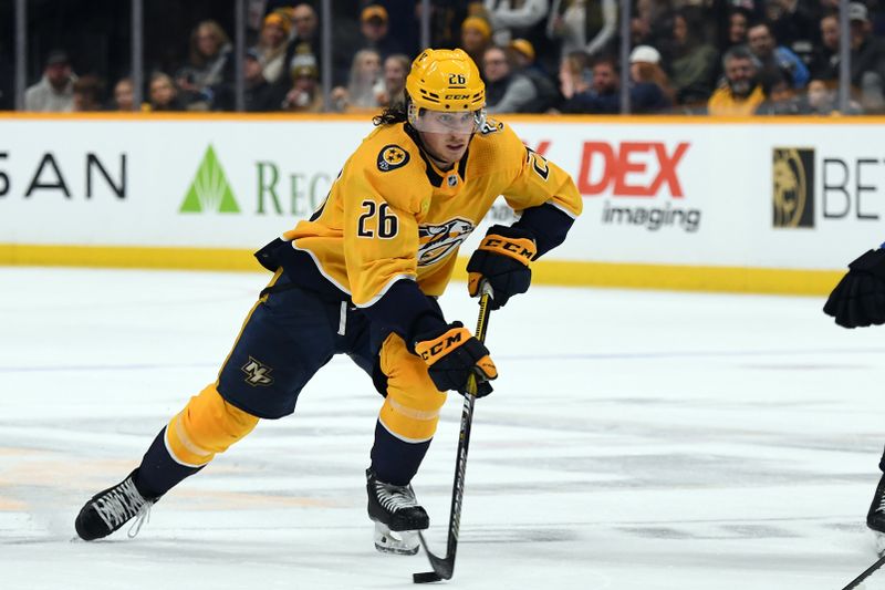 Nov 26, 2023; Nashville, Tennessee, USA; Nashville Predators center Philip Tomasino (26) handles the puck during the third period against the Winnipeg Jets at Bridgestone Arena. Mandatory Credit: Christopher Hanewinckel-USA TODAY Sports