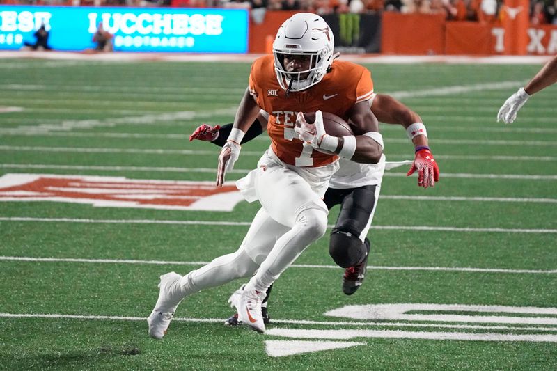 Nov 24, 2023; Austin, Texas, USA; Texas Longhorns running back Keilan Robinson (7) runs for a touchdown during the first half against the Texas Tech Red Raiders at Darrell K Royal-Texas Memorial Stadium. Mandatory Credit: Scott Wachter-USA TODAY Sports