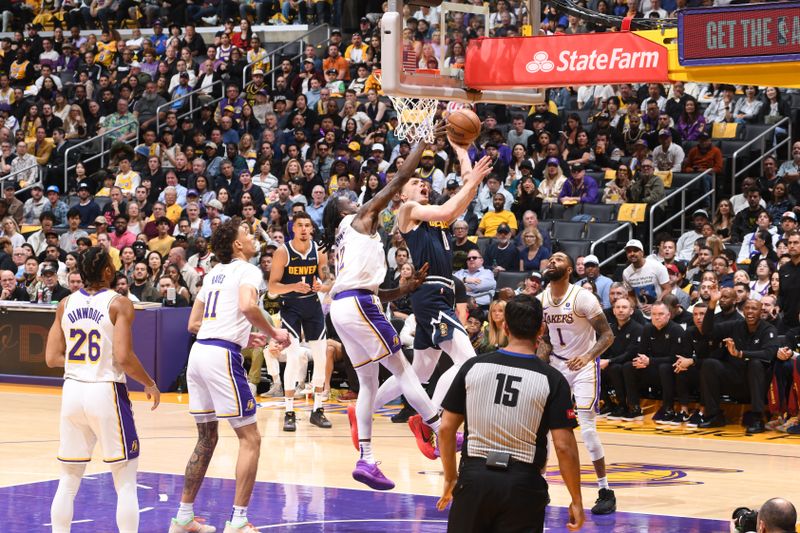 LOS ANGELES, CA - APRIL 27: Christian Braun #0 of the Denver Nuggets drives to the basket during the game against the Los Angeles Lakers during Round 1 Game 4 of the 2024 NBA Playoffs on April 27, 2024 at Crypto.Com Arena in Los Angeles, California. NOTE TO USER: User expressly acknowledges and agrees that, by downloading and/or using this Photograph, user is consenting to the terms and conditions of the Getty Images License Agreement. Mandatory Copyright Notice: Copyright 2024 NBAE (Photo by Andrew D. Bernstein/NBAE via Getty Images)