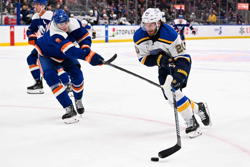 Mar 5, 2024; Elmont, New York, USA;  St. Louis Blues left wing Brandon Saad (20) skates with the puck defended by New York Islanders defenseman Noah Dobson (8) during the third period at UBS Arena. Mandatory Credit: Dennis Schneidler-USA TODAY Sports