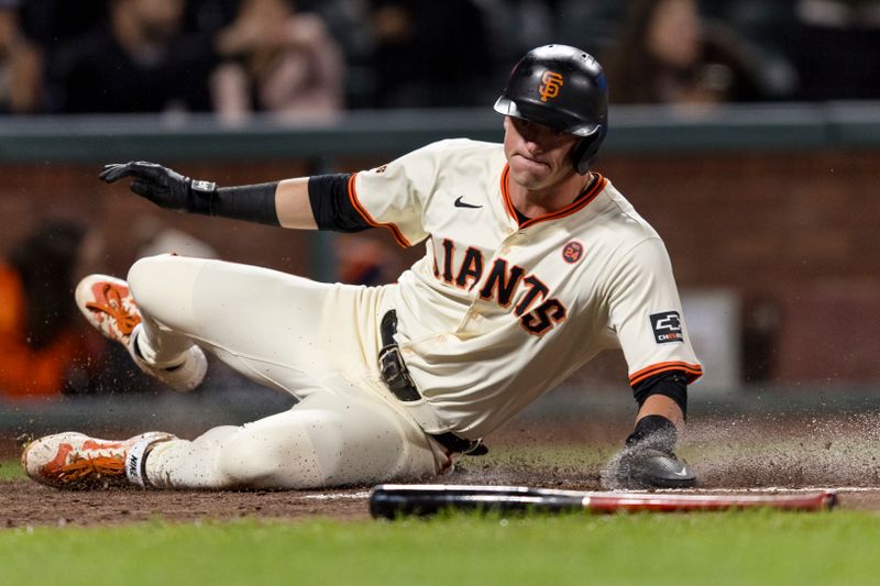 Sep 11, 2024; San Francisco, California, USA; San Francisco Giants shortstop Tyler Fitzgerald (49) slides home to score against the Milwaukee Brewers during the fourth inning at Oracle Park. Mandatory Credit: John Hefti-Imagn Images