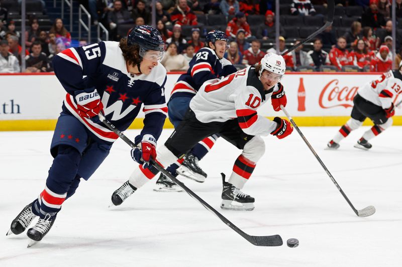 Feb 20, 2024; Washington, District of Columbia, USA; Washington Capitals left wing Sonny Milano (15) skates with the puck as New Jersey Devils right wing Alexander Holtz (10) chases in the first period at Capital One Arena. Mandatory Credit: Geoff Burke-USA TODAY Sports