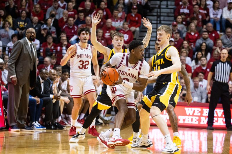 Jan 30, 2024; Bloomington, Indiana, USA; Indiana Hoosiers guard Xavier Johnson (0) looks to pass the ball while Iowa Hawkeyes guard Josh Dix (4) defends in the second half at Simon Skjodt Assembly Hall. Mandatory Credit: Trevor Ruszkowski-USA TODAY Sports