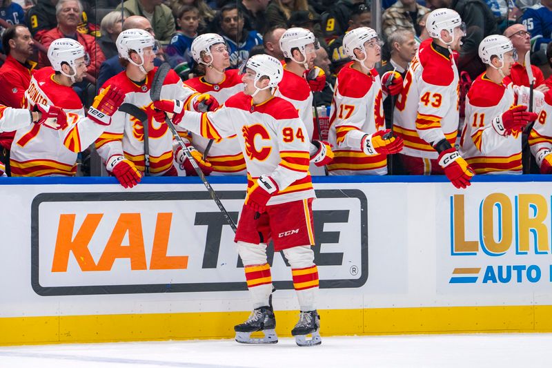 Apr 16, 2024; Vancouver, British Columbia, CAN; Calgary Flames defenseman Brayden Pachal (94) celebrates his goal against the Vancouver Canucks in the third period at Rogers Arena. Canucks won 4 -1. Mandatory Credit: Bob Frid-USA TODAY Sports