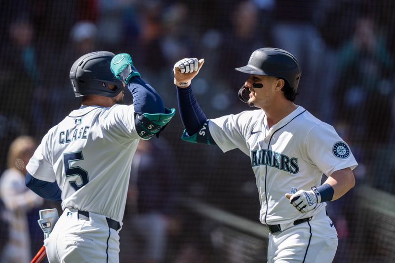 Apr 17, 2024; Seattle, Washington, USA; Seattle Mariners third baseman Josh Rojas (4) celebrates with left fielder Jonatan Clase (5) after hitting a solo home run during the seventh inning against the Cincinnati Reds at T-Mobile Park. Mandatory Credit: Stephen Brashear-USA TODAY Sports