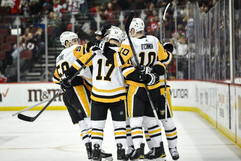 Apr 2, 2024; Newark, New Jersey, USA; Pittsburgh Penguins center Sidney Crosby (87) celebrates with teammates after scoring a goal against the New Jersey Devils during the third period at Prudential Center. Mandatory Credit: John Jones-USA TODAY Sports