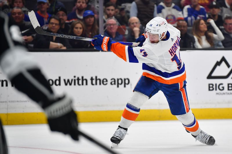 Mar 11, 2024; Los Angeles, California, USA; New York Islanders center Bo Horvat (14) shoots on goal against the Los Angeles Kings during the third period at Crypto.com Arena. Mandatory Credit: Gary A. Vasquez-USA TODAY Sports