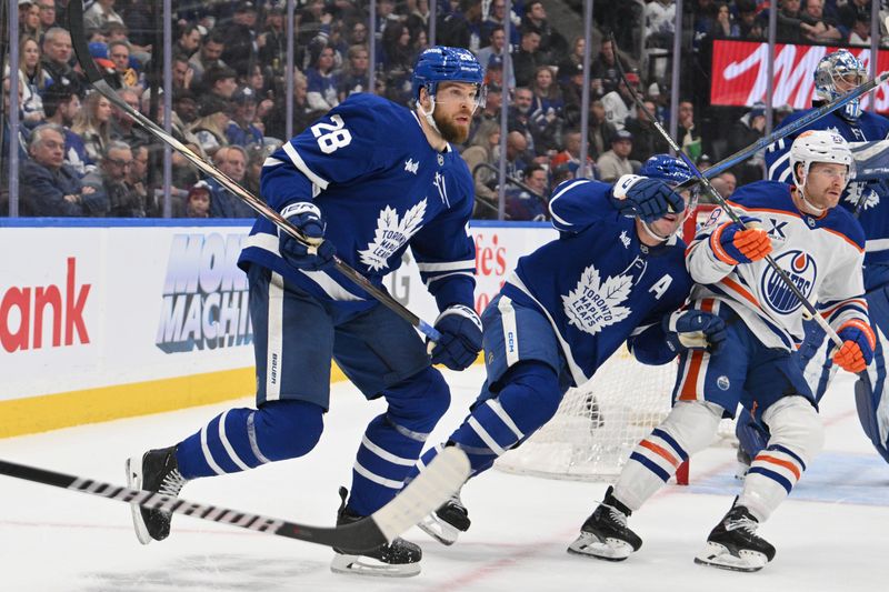 Nov 16, 2024; Toronto, Ontario, CAN;  Toronto Maple Leafs defenseman Jani Hakanpaa (28) pursues the play against the Edmonton Oilers in the second period. Mandatory Credit: Dan Hamilton-Imagn Images