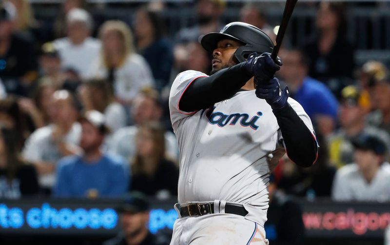 Sep 30, 2023; Pittsburgh, Pennsylvania, USA; Miami Marlins first baseman Josh Bell (9) hits a two run double against the Pittsburgh Pirates during the eighth inning at PNC Park. Mandatory Credit: Charles LeClaire-USA TODAY Sports