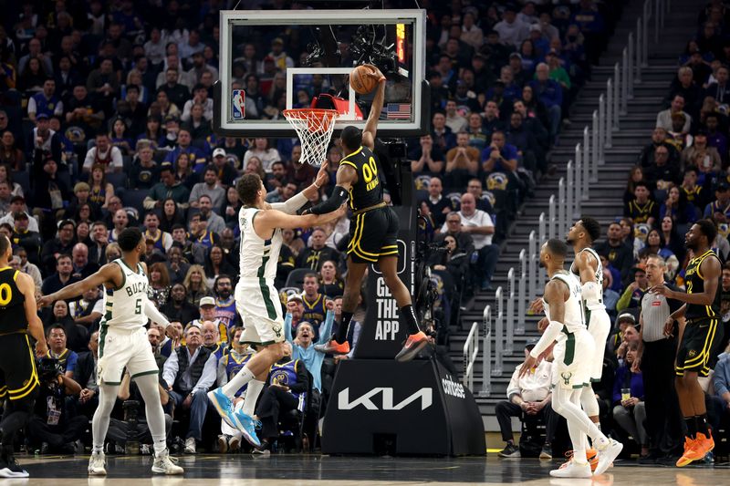 SAN FRANCISCO, CALIFORNIA - MARCH 06: Jonathan Kuminga #00 of the Golden State Warriors dunks the ball on Brook Lopez #11 of the Milwaukee Buckss at Chase Center on March 06, 2024 in San Francisco, California. NOTE TO USER: User expressly acknowledges and agrees that, by downloading and or using this photograph, User is consenting to the terms and conditions of the Getty Images License Agreement.  (Photo by Ezra Shaw/Getty Images)