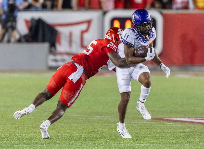 Sep 16, 2023; Houston, Texas, USA;TCU Horned Frogs wide receiver JoJo Earle (11) breaks a tackle bu Houston Cougars linebacker Jamal Morris (25) in the first half at TDECU Stadium. Mandatory Credit: Thomas Shea-USA TODAY Sports